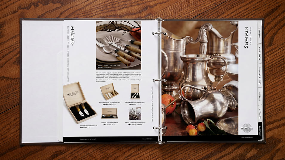 Photo of Arte Italica Serveware section of print catalog on oak table